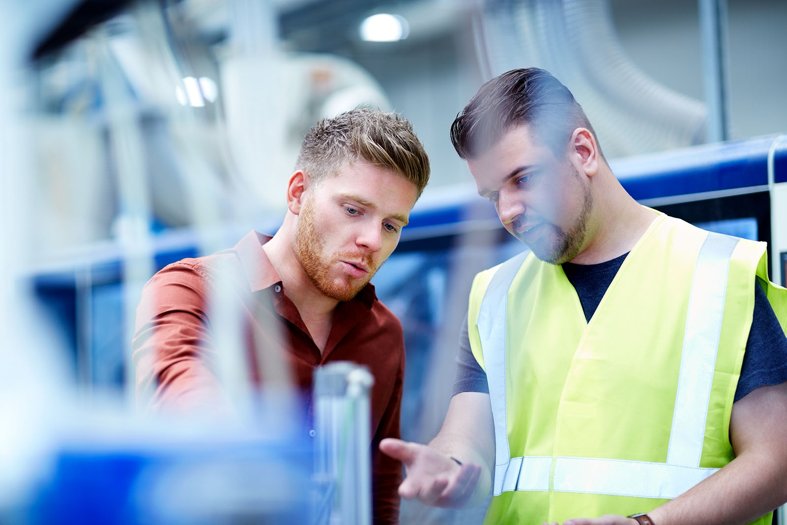 Young men working in manufacturing facility Young men working